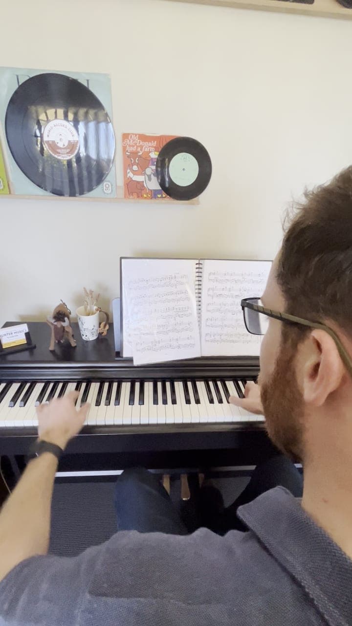 Watching over Micah's shoulder as he practices for his AMusA